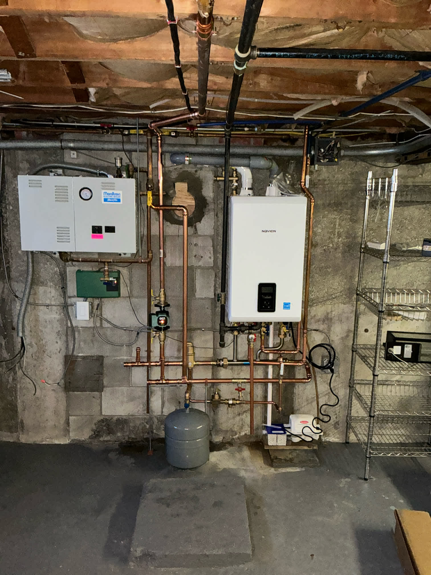 At Akian Plumbing, Heating, Cooling & Electric, we ensure your home systems are both efficient and expertly installed, as seen in this organized heating setup.