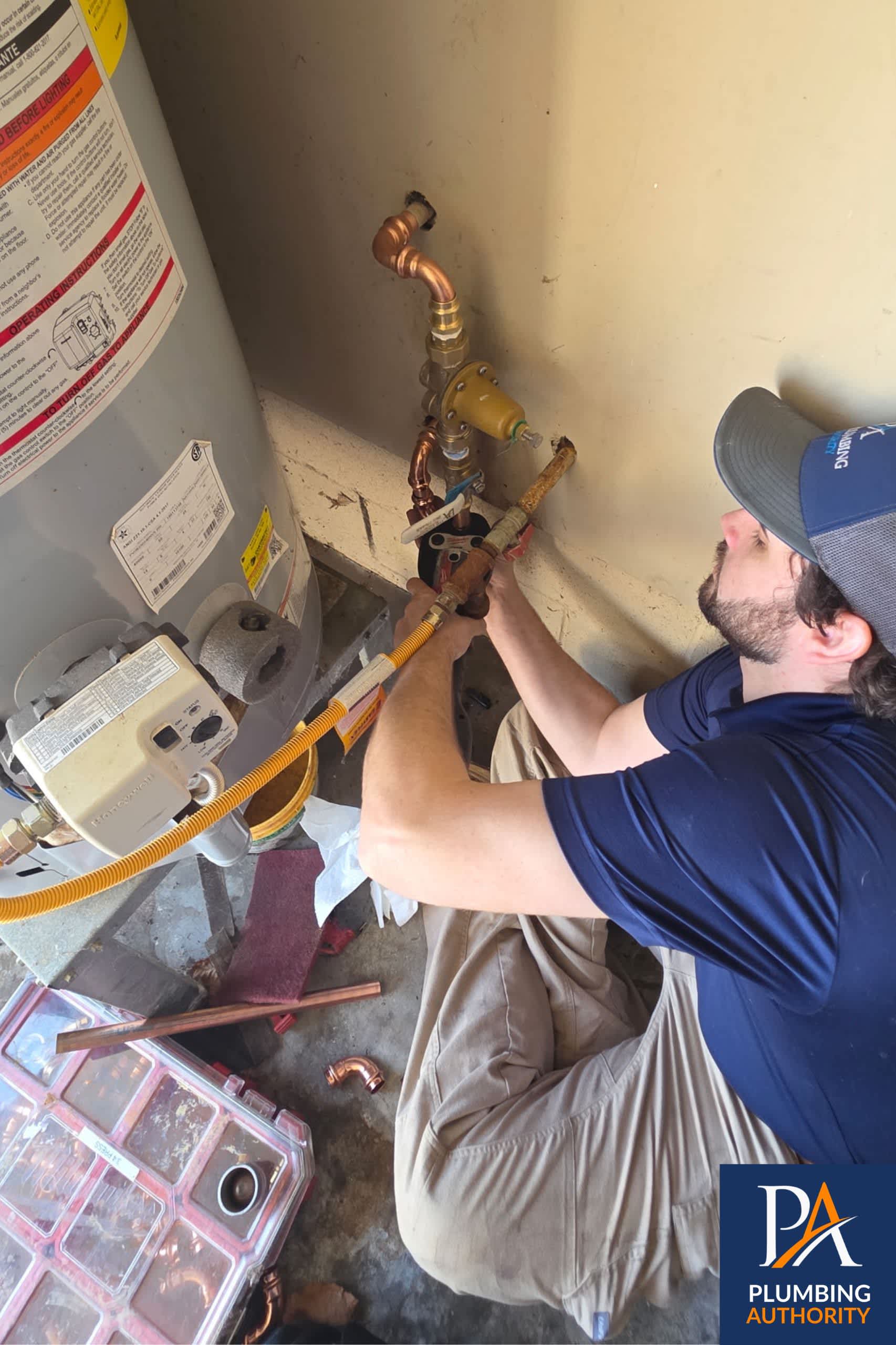 A skilled Plumbing Authority technician carefully restores your water heater connections, showcasing dependable workmanship and honest service.