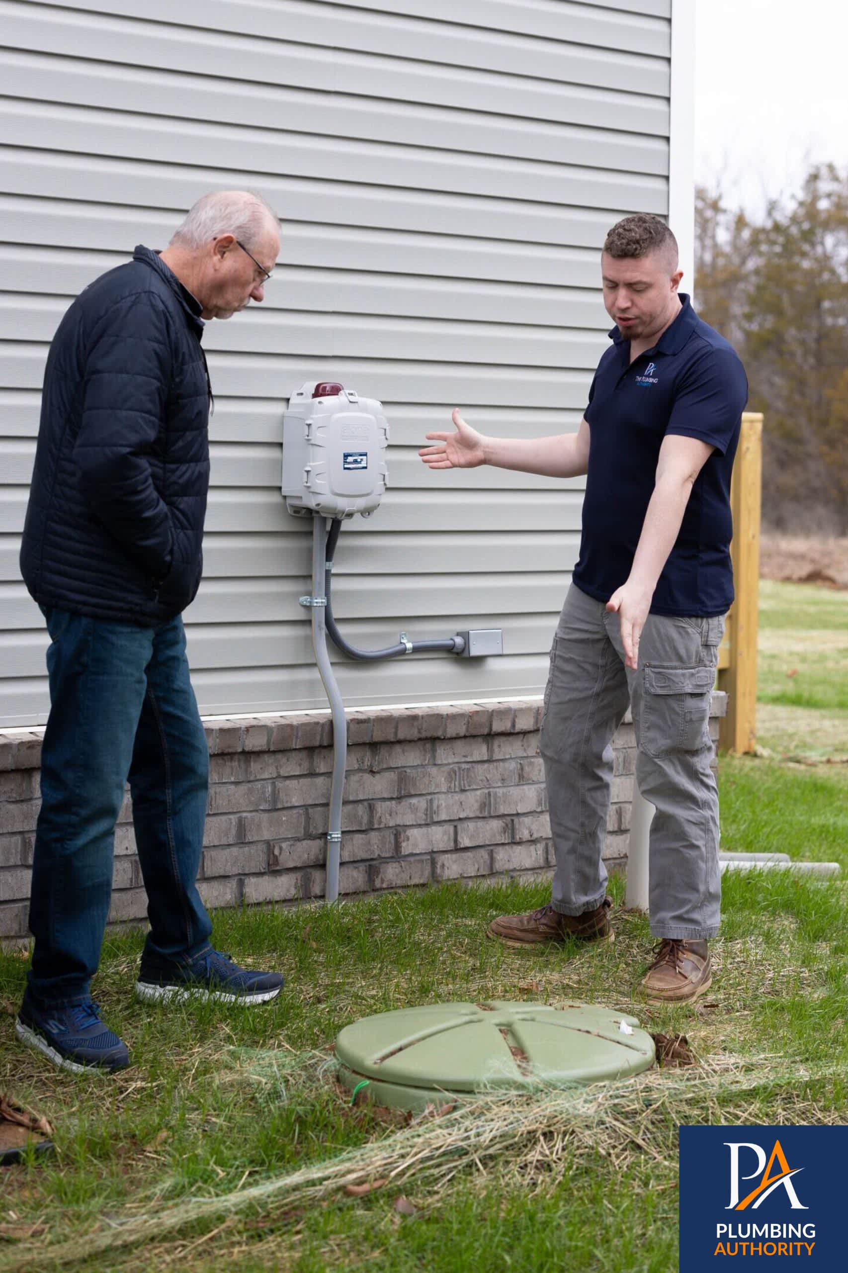 A friendly Plumbing Authority technician inspects outdoor connections and explains the solution, giving homeowners confidence in our workmanship.