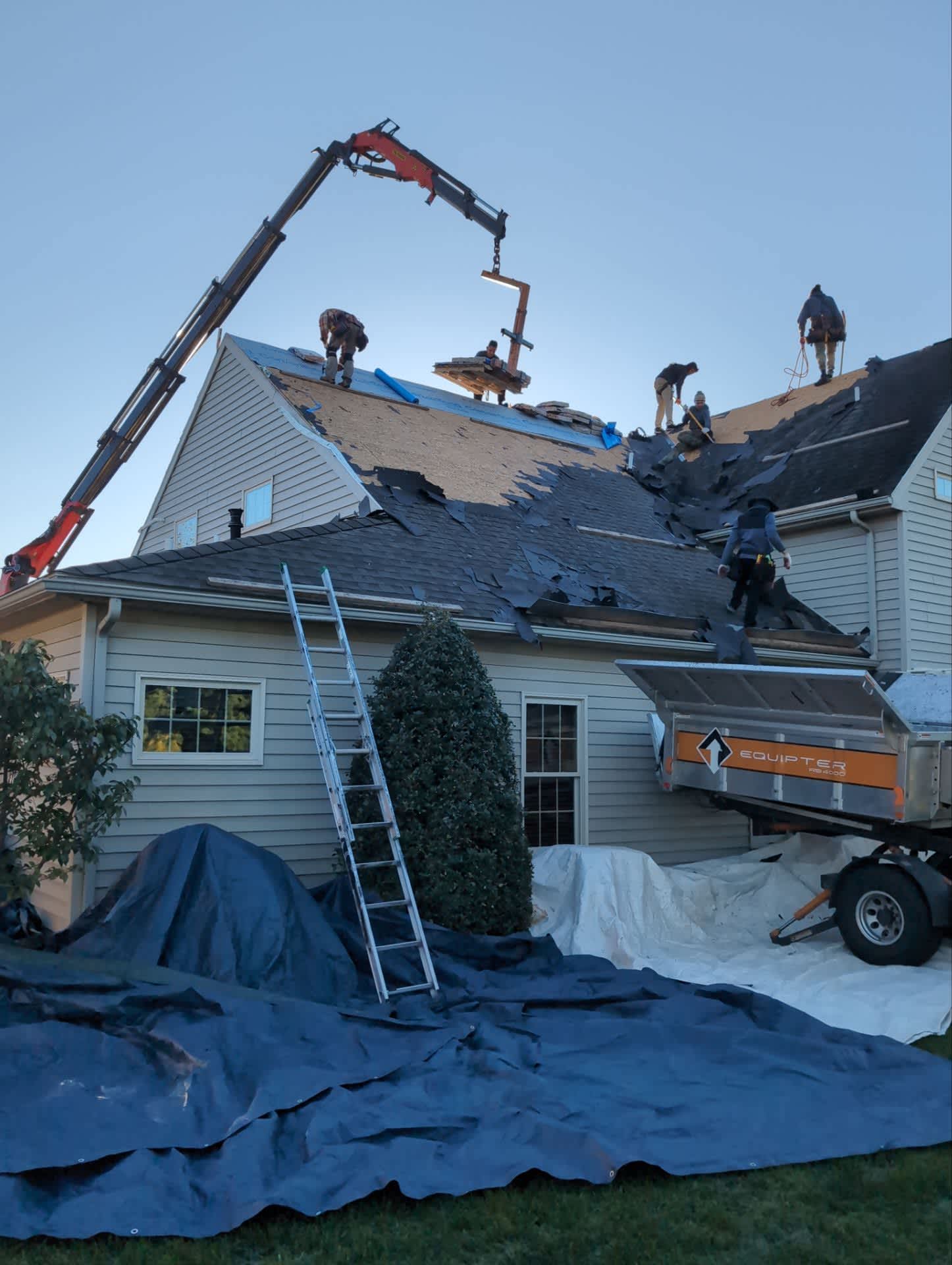 Skilled professionals from Mosaic Roofing & Exteriors are replacing this roof with careful site protection and efficient material handling.