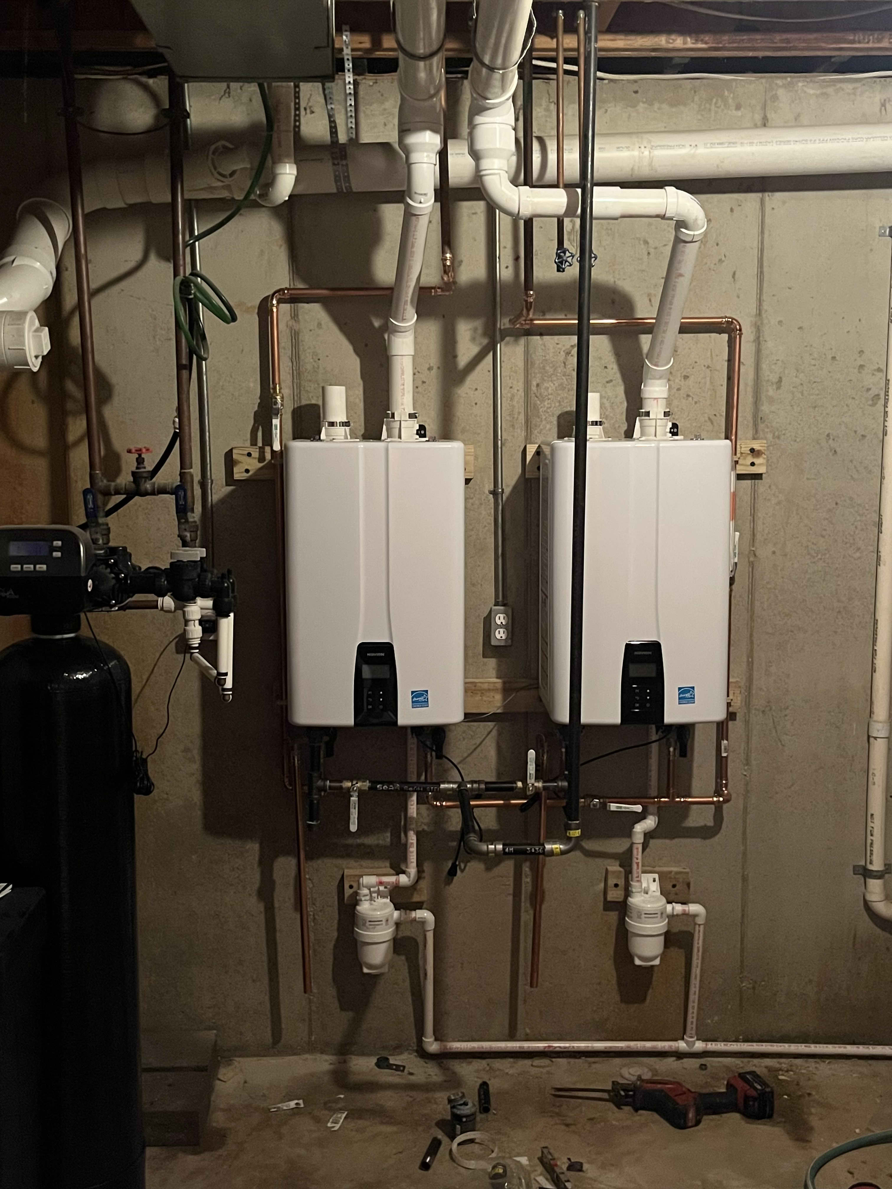 Reliable tankless hot water installation with clean copper piping and thoughtful layout, delivered by Summers Plumbing Heating & Cooling to boost capacity and reliability.