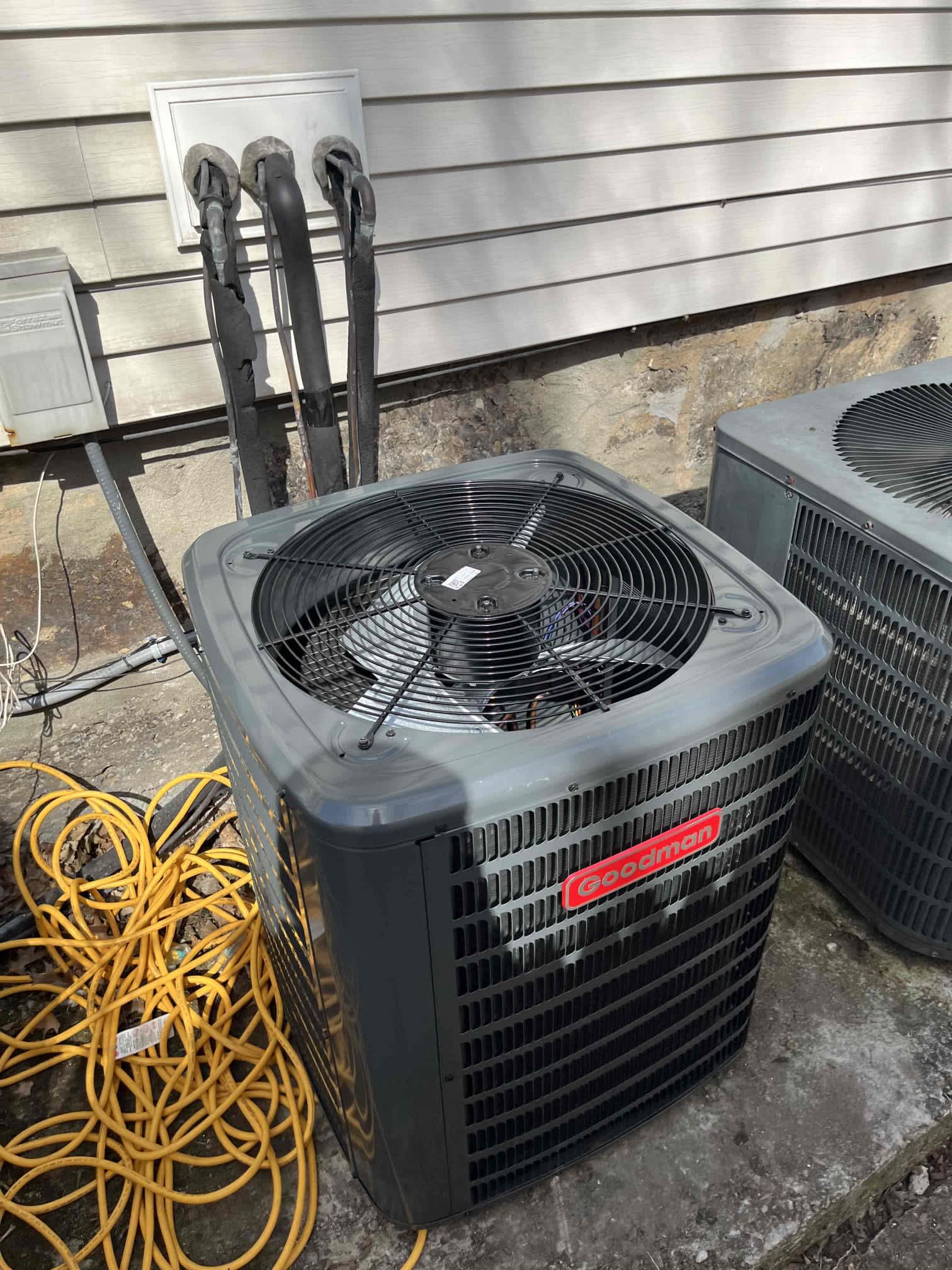 A clean Goodman outdoor unit shows reliable craftsmanship and value for homeowners, installed and serviced by Akian Plumbing, Heating, Cooling & Electric.