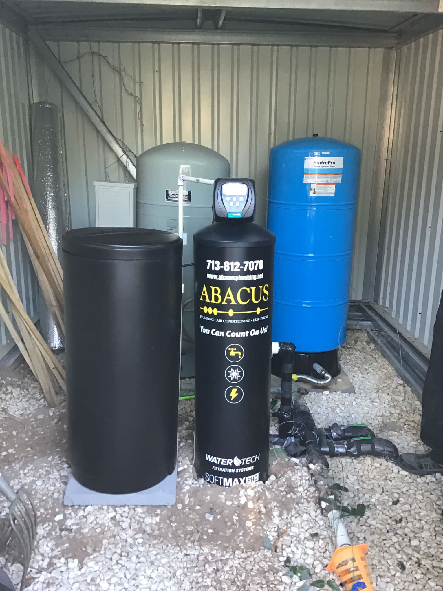 Reliable water treatment installed and labeled for peace of mind, Abacus Plumbing, Air Conditioning & Electrical shows professional, organized workmanship.