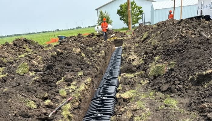 Lanz Plumbing, Heating & Cooling, Inc. showcasing professional trenching and pipe installation services.