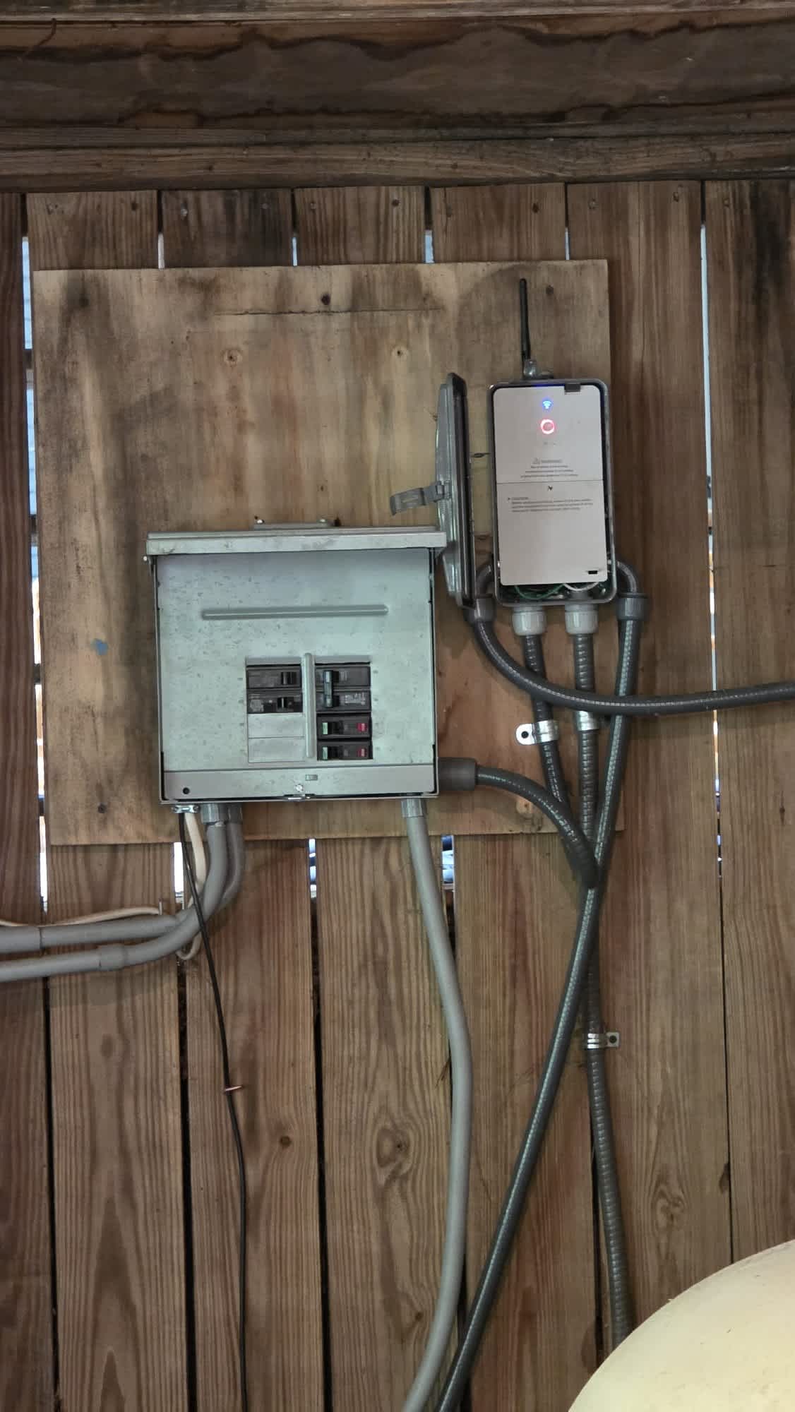 Dependable outdoor electrical work by Aardvark Electric, Inc. shows neat conduit routing and a secure breaker installation for long term reliability.