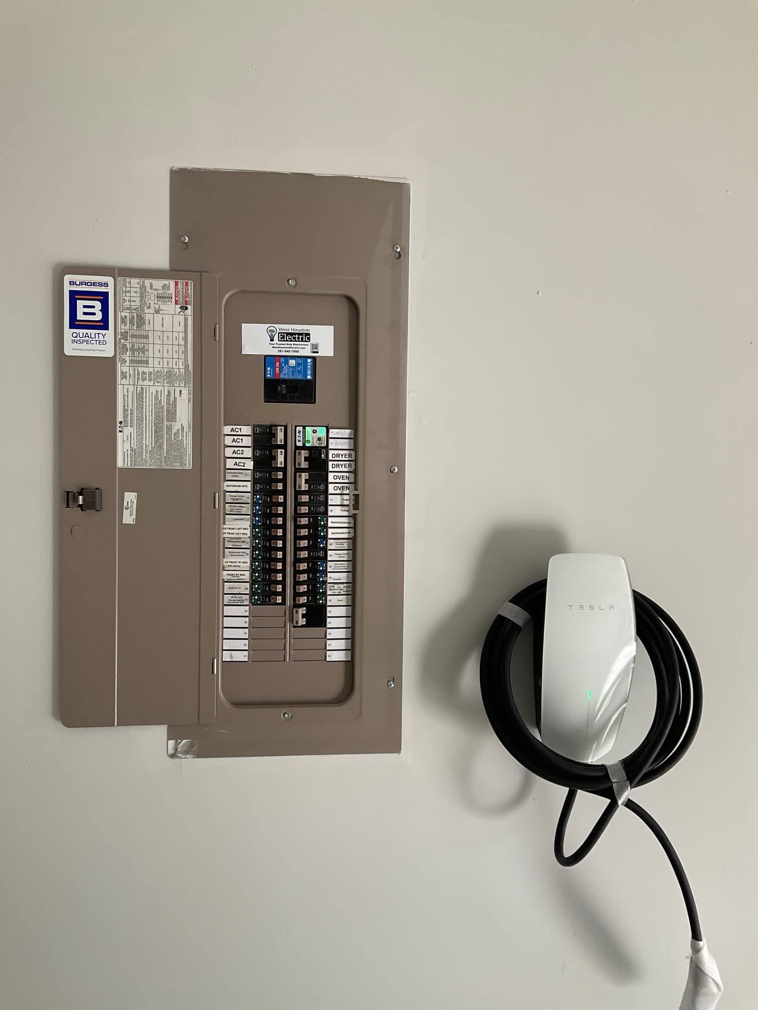 A clean, professional EV charger and labeled electrical panel show how West Houston Electric, Inc. delivers reliable, code‑conscious installations.