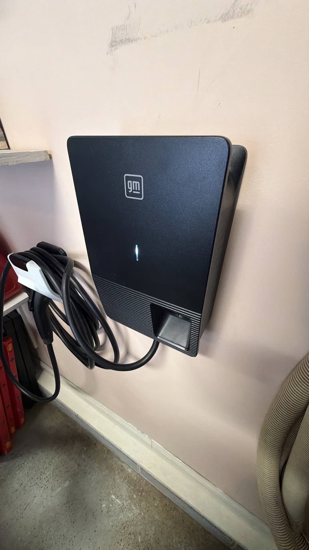 Clean, professional EV charger installation in a residential garage shows Atomic Electric Service Inc. delivering reliable, tidy charging solutions.