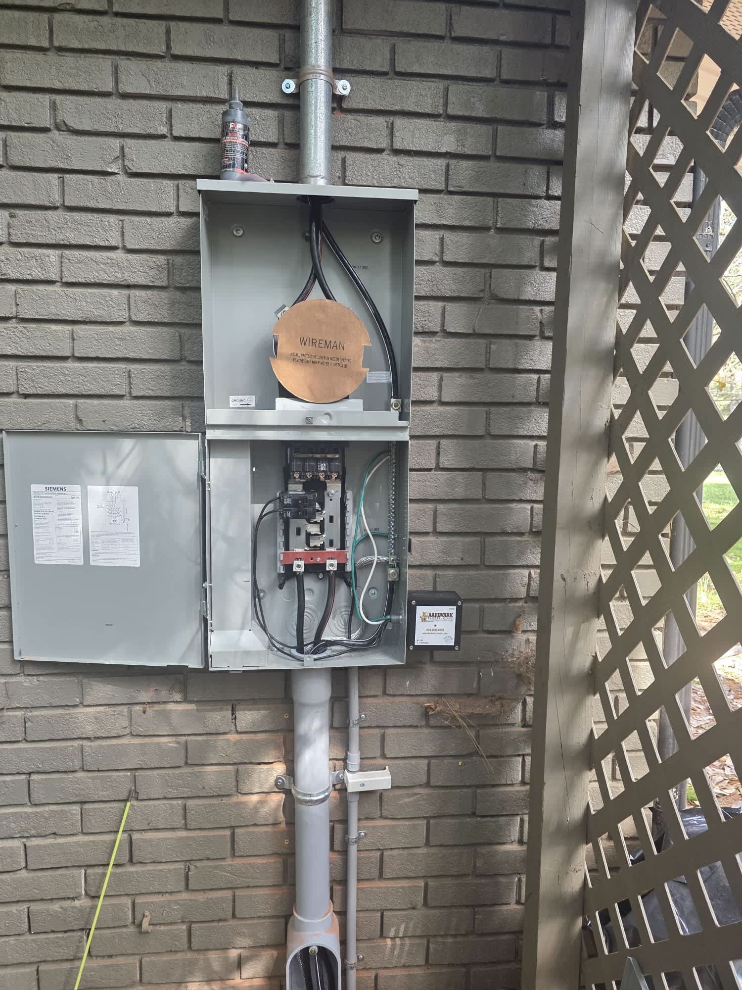 Clean, professional electrical service work on an exterior panel shows Aardvark Electric, Inc.'s commitment to safe, reliable installations.