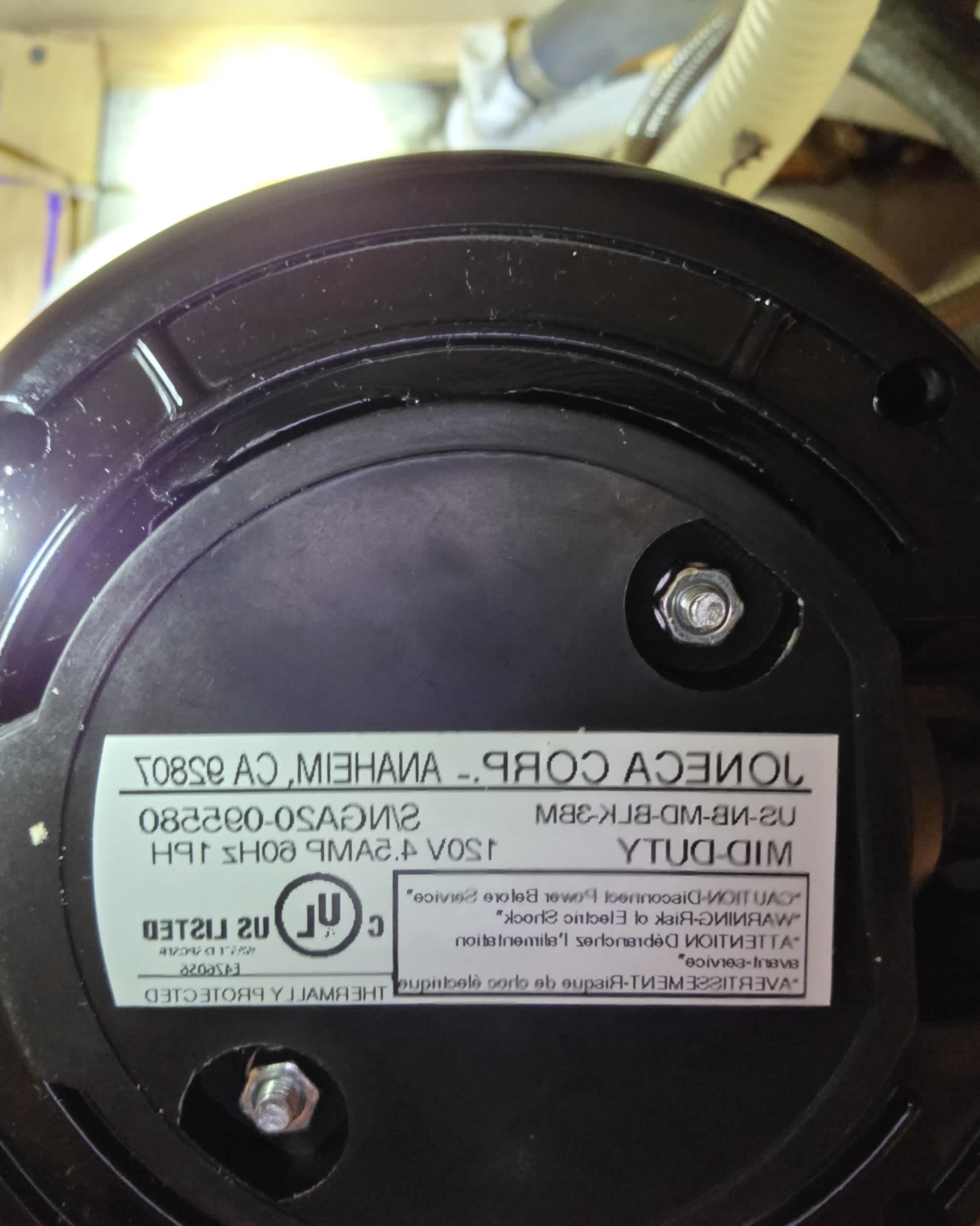 A detailed close-up shows careful component installation and inspection by Abacus Plumbing, Air Conditioning & Electrical, highlighting workmanship and reliability.