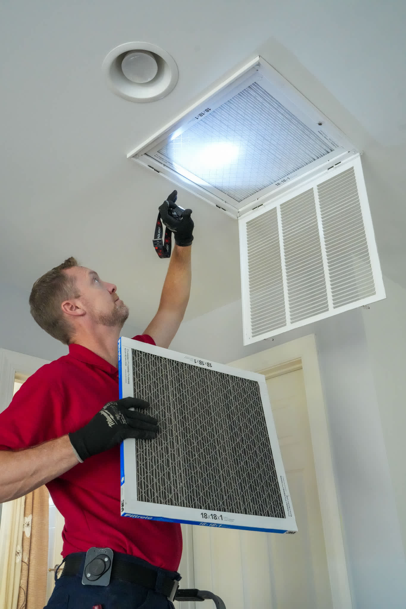 Reliable, professional HVAC maintenance from Parrish Services shows attentive technicians replacing air filters for cleaner, healthier home air.