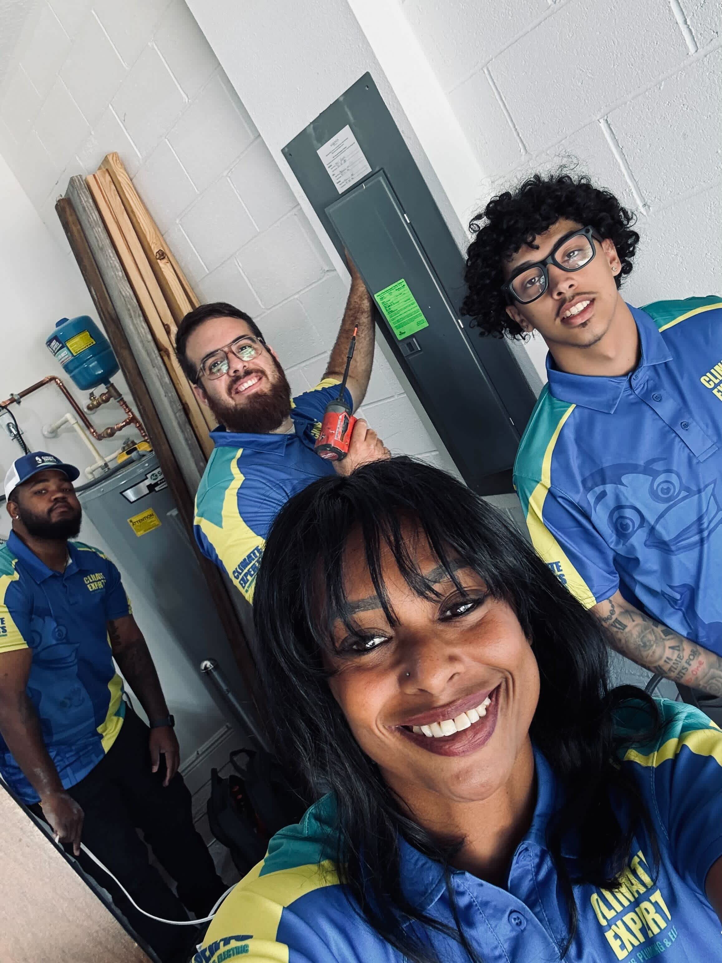 Smiling technicians from Climate Experts Air, Plumbing & Electric showcase friendly, professional service and careful workmanship for every job.