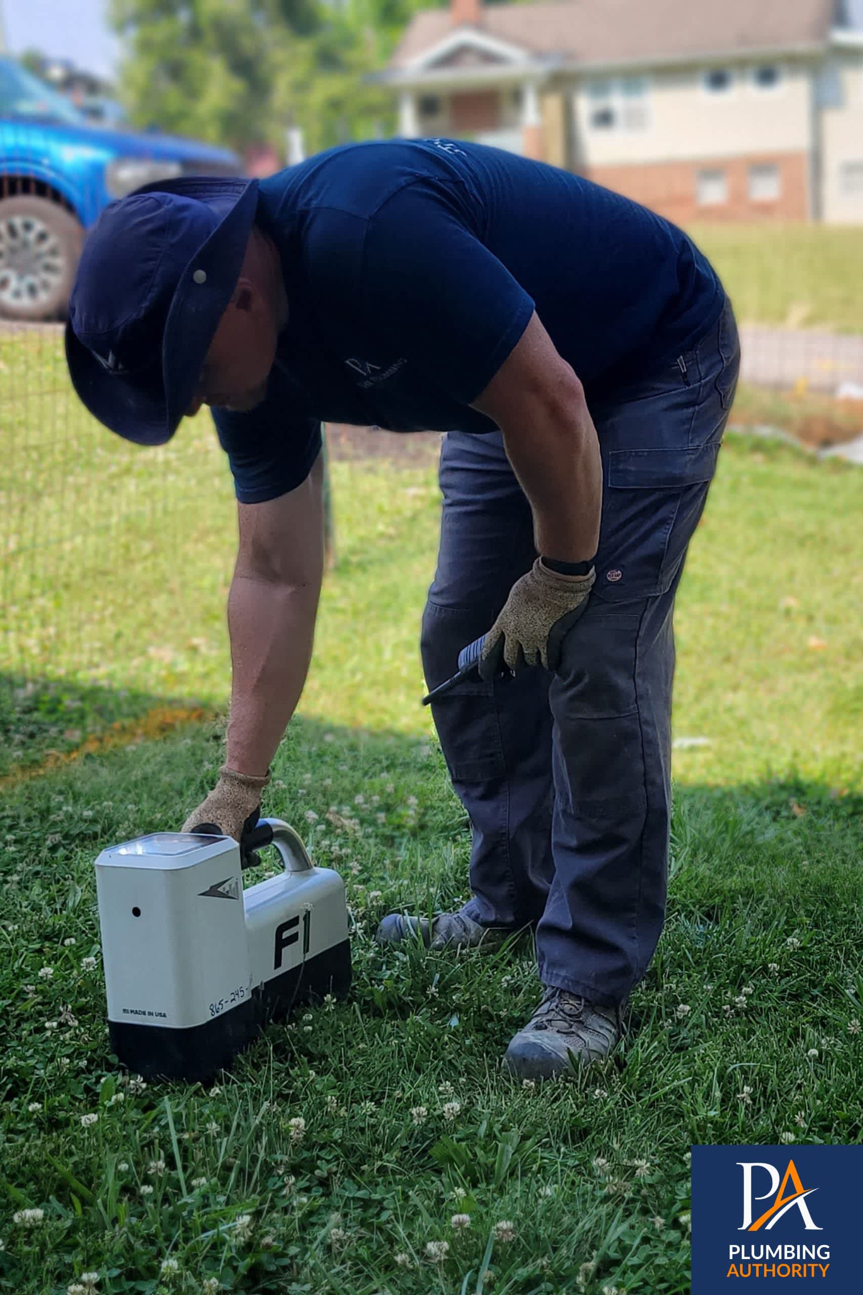 A skilled technician from The Plumbing Authority performs careful on-site testing, demonstrating craftsmanship and dependable service for homeowners.