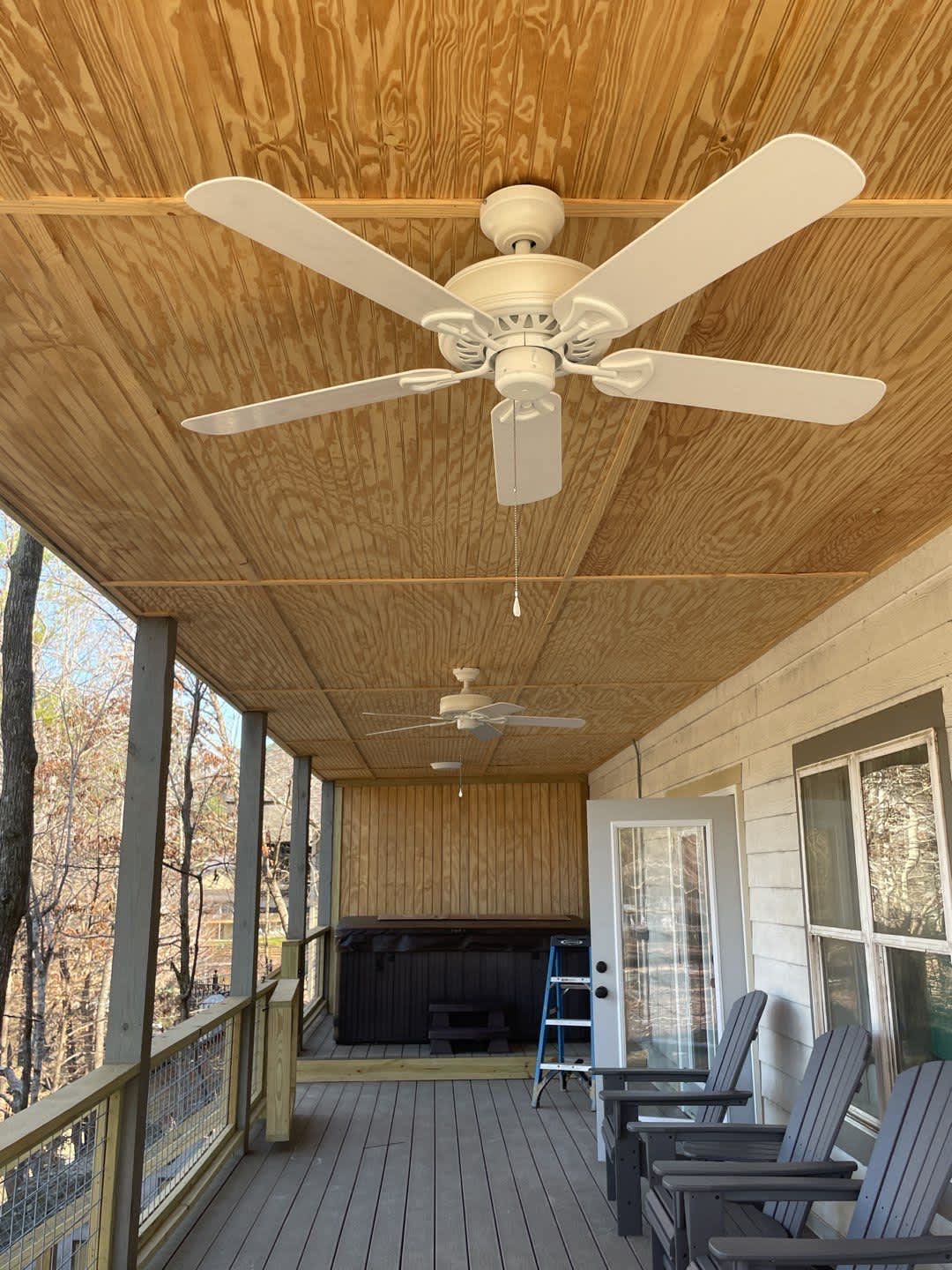 A comfortable covered porch finished by C&T Electric LLC showcases quality ceiling fan installation and inviting outdoor living space.