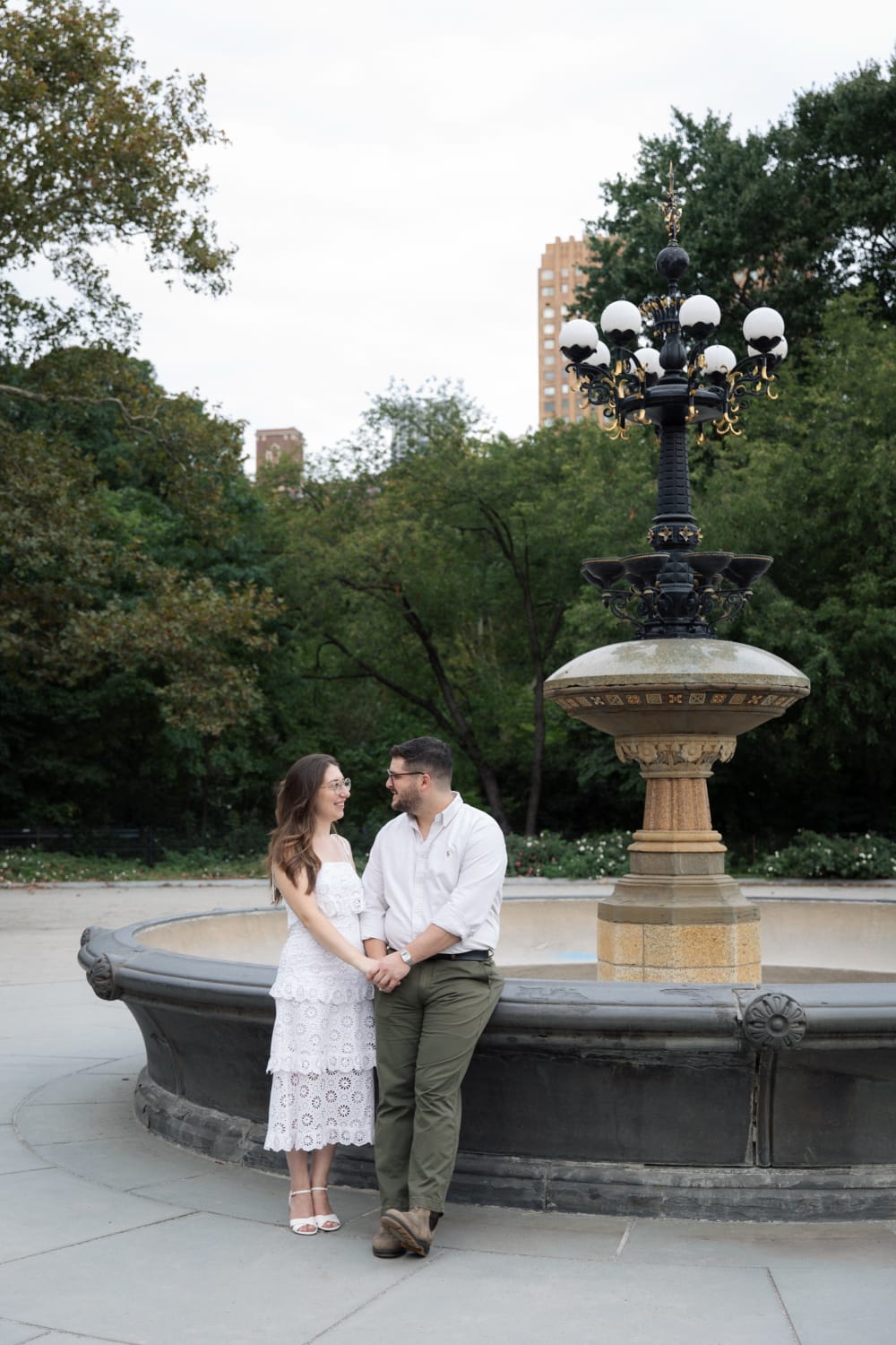 Sydney and Braden holding hands in front of the Cherry Hill fountain, Central Park