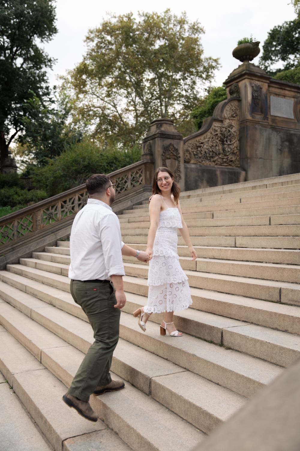 Sydney leading Braden up the stone steps of Bethesda Terrace