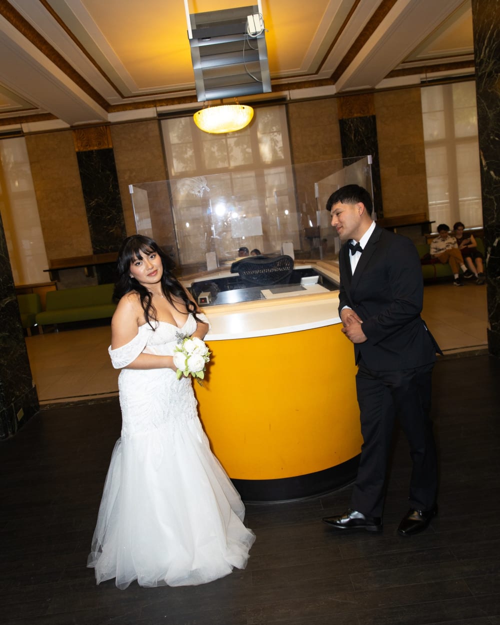 Couple at the counter of the Office of the City Clerk before their New York elopement