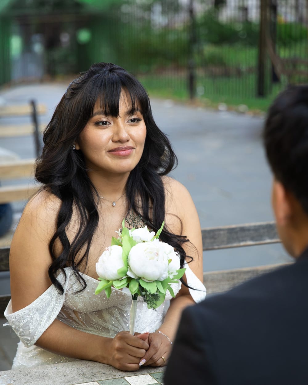 Bride holding her bouquet in City Hall Park after her Manhattan elopement