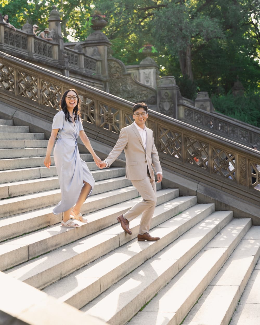 Kevin and Karen holding hands as they walk down the Bethesda Terrace steps in Central Park