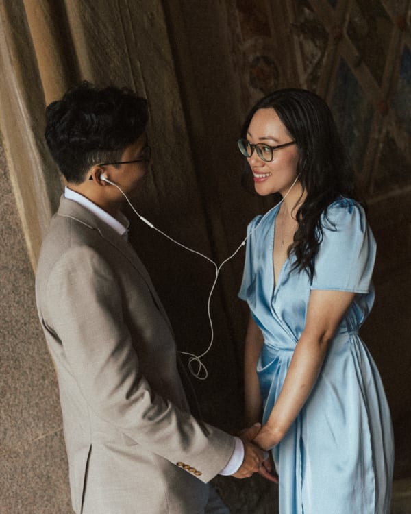 Kevin and Karen sharing earbuds under the Bethesda arcade