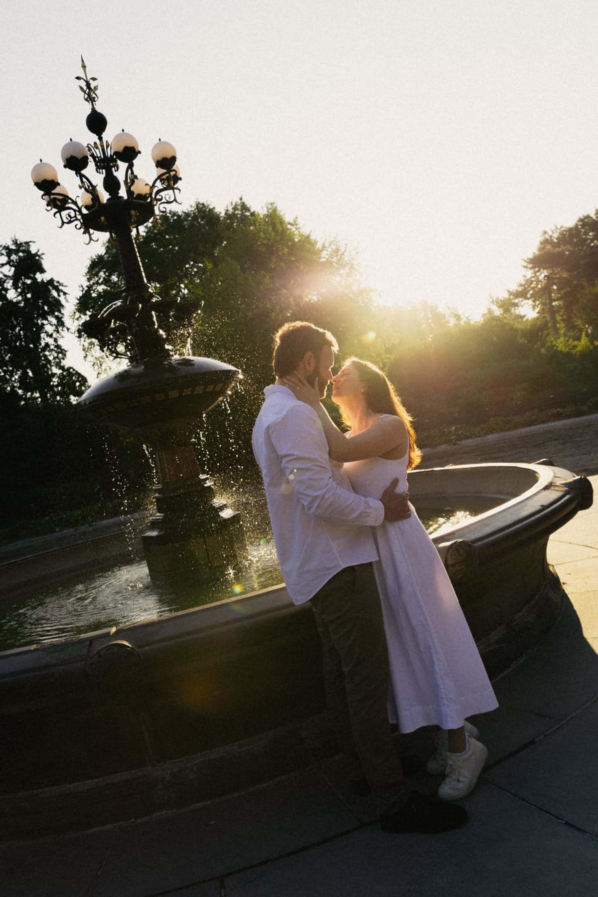 A couple embracing by the Bethesda Fountain in Central Park at golden hour