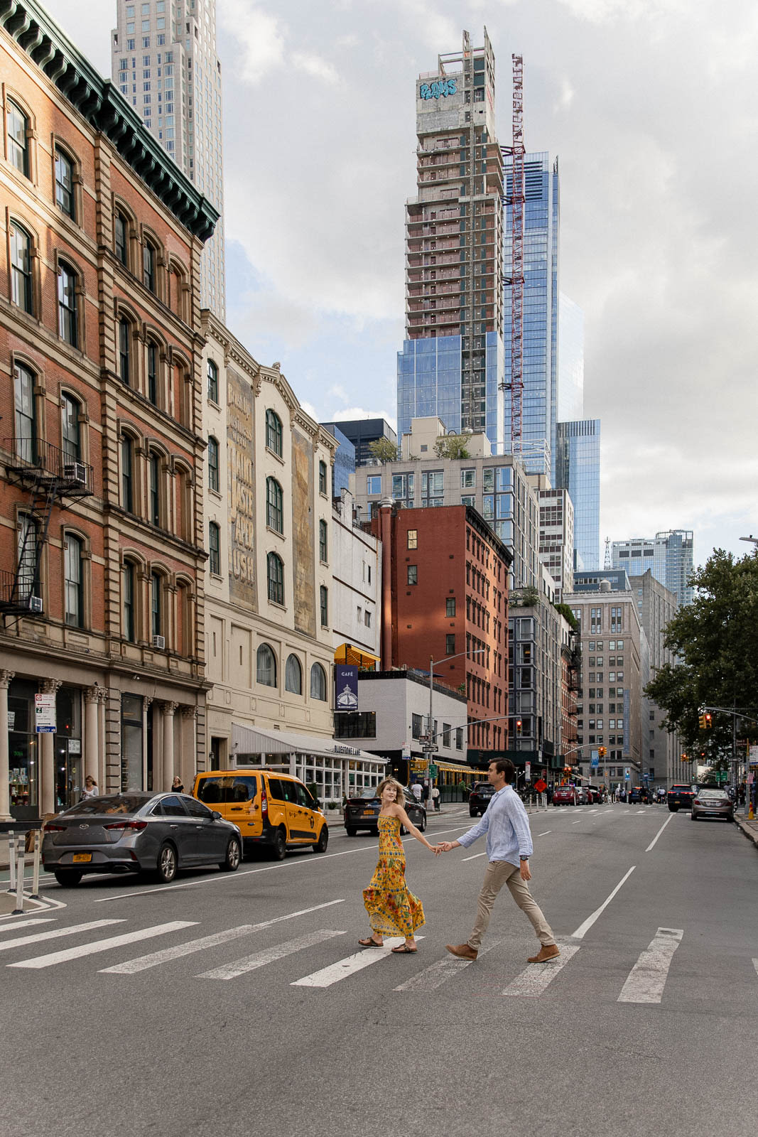 Couple standing close together, hands touching, during a portrait session in New York