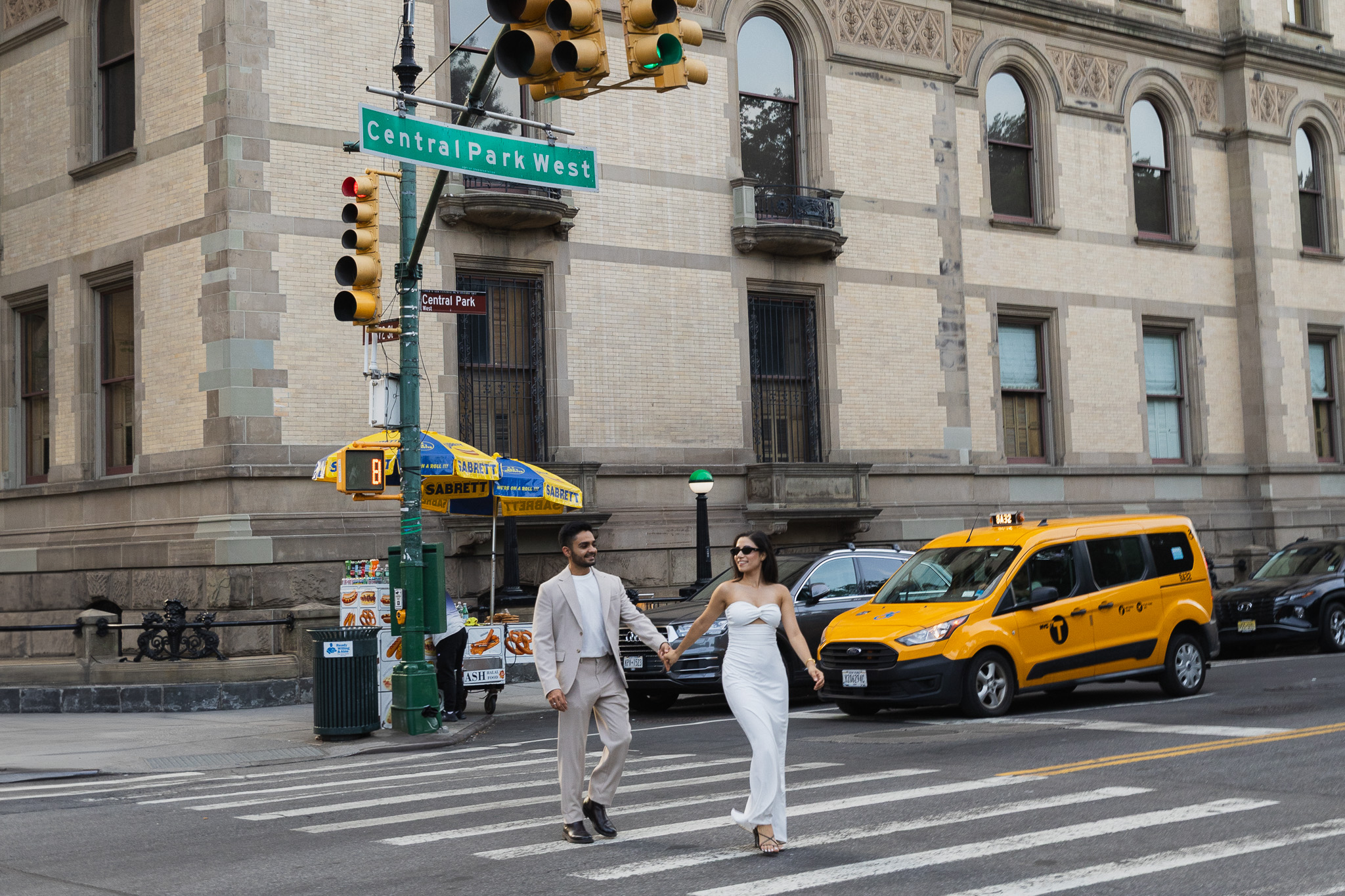 Crossing 72nd Street at the entrance to Central Park, yellow cabs and old apartment buildings in the background