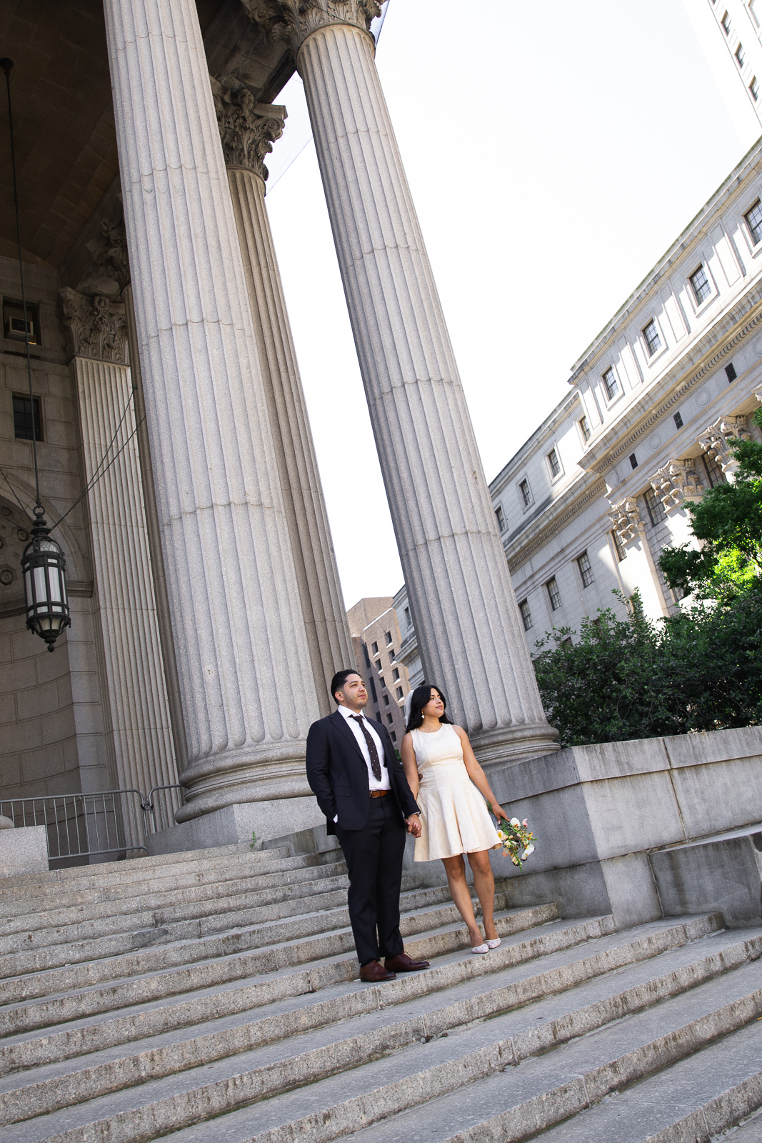 Patricia and Carlos photographed outside the green doors of the Marriage Bureau at 141 Worth Street