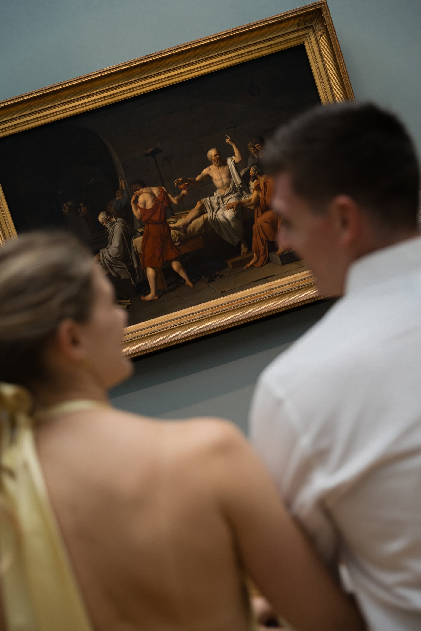 Couple looking up at a painting during a photo session at the Metropolitan Museum of Art