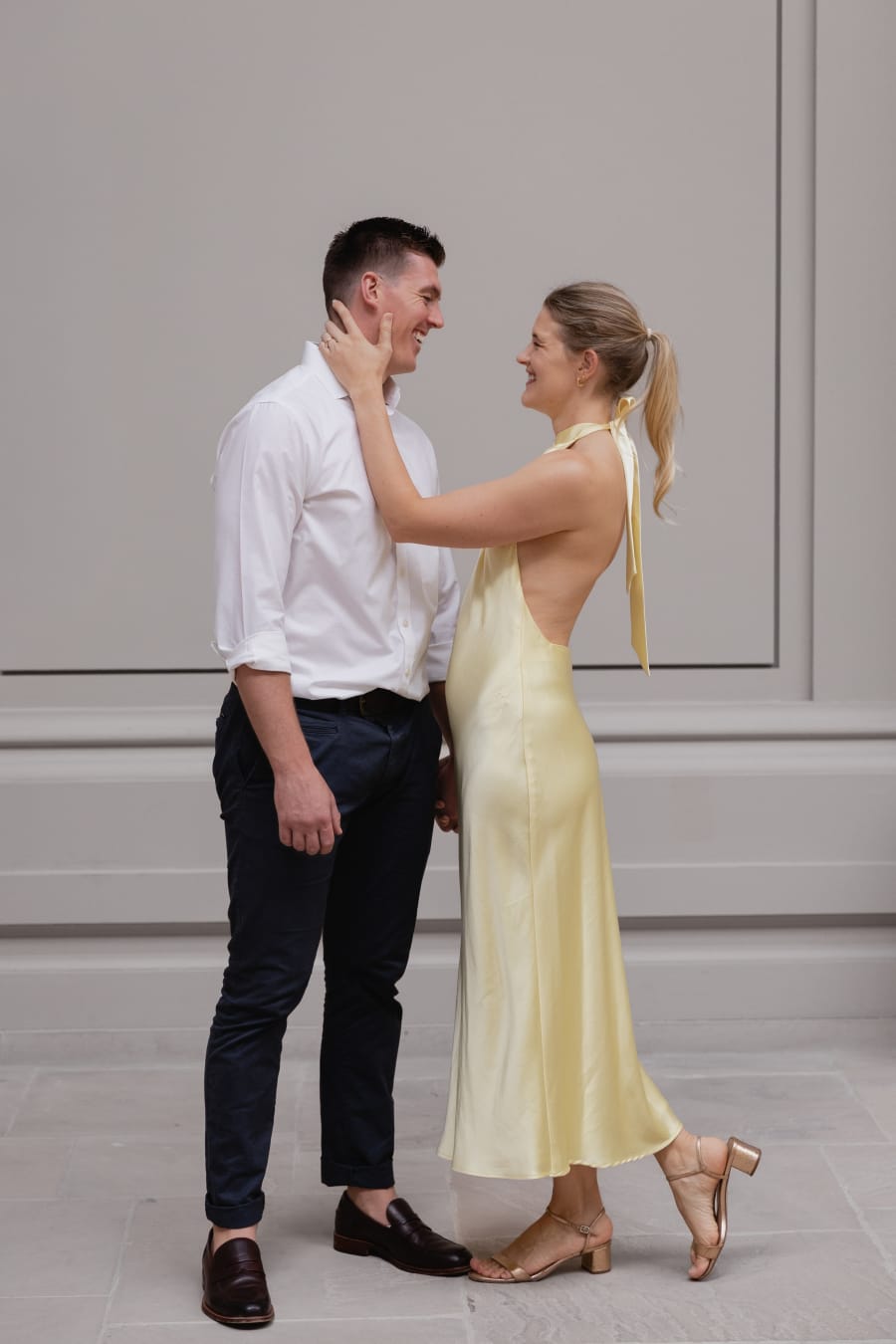 Nicole and Ryan inside the Met, her hand on his cheek