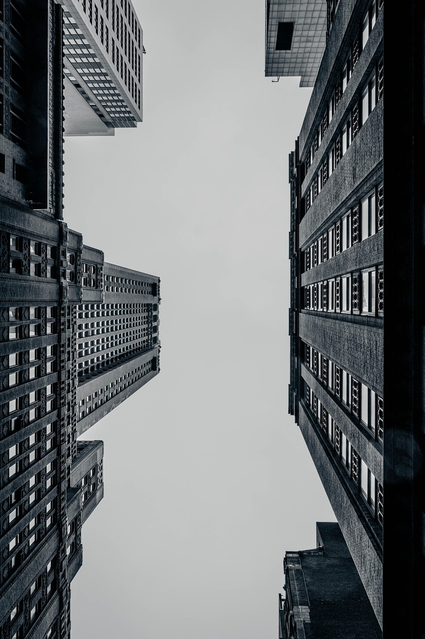 A real estate agent showing a couple around a property, tablet in hand with listing details visible