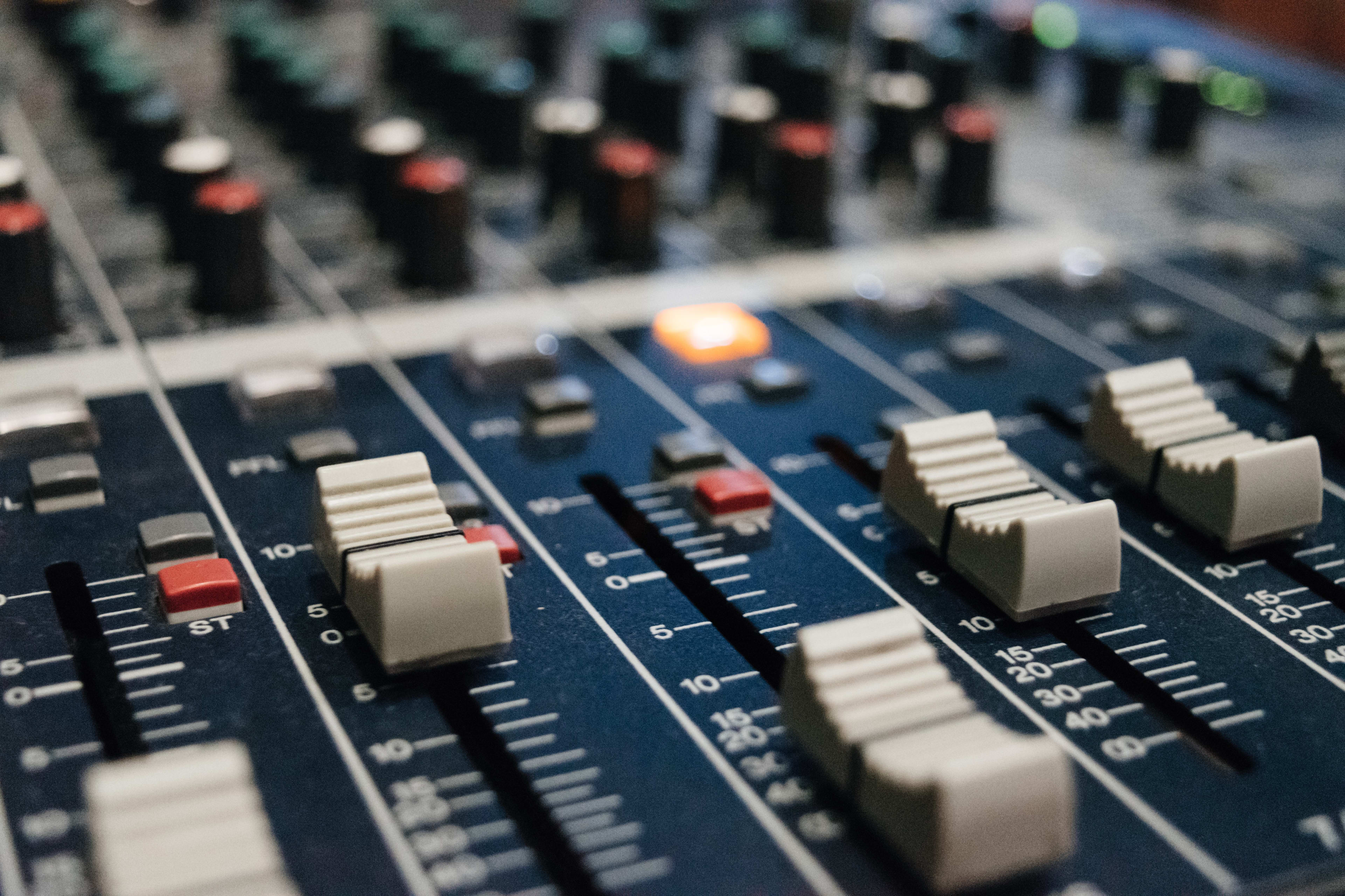 Photo of a blue, high-quality music studio mixing desk