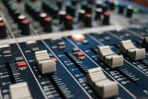 Photo of a blue, high-quality music studio mixing desk