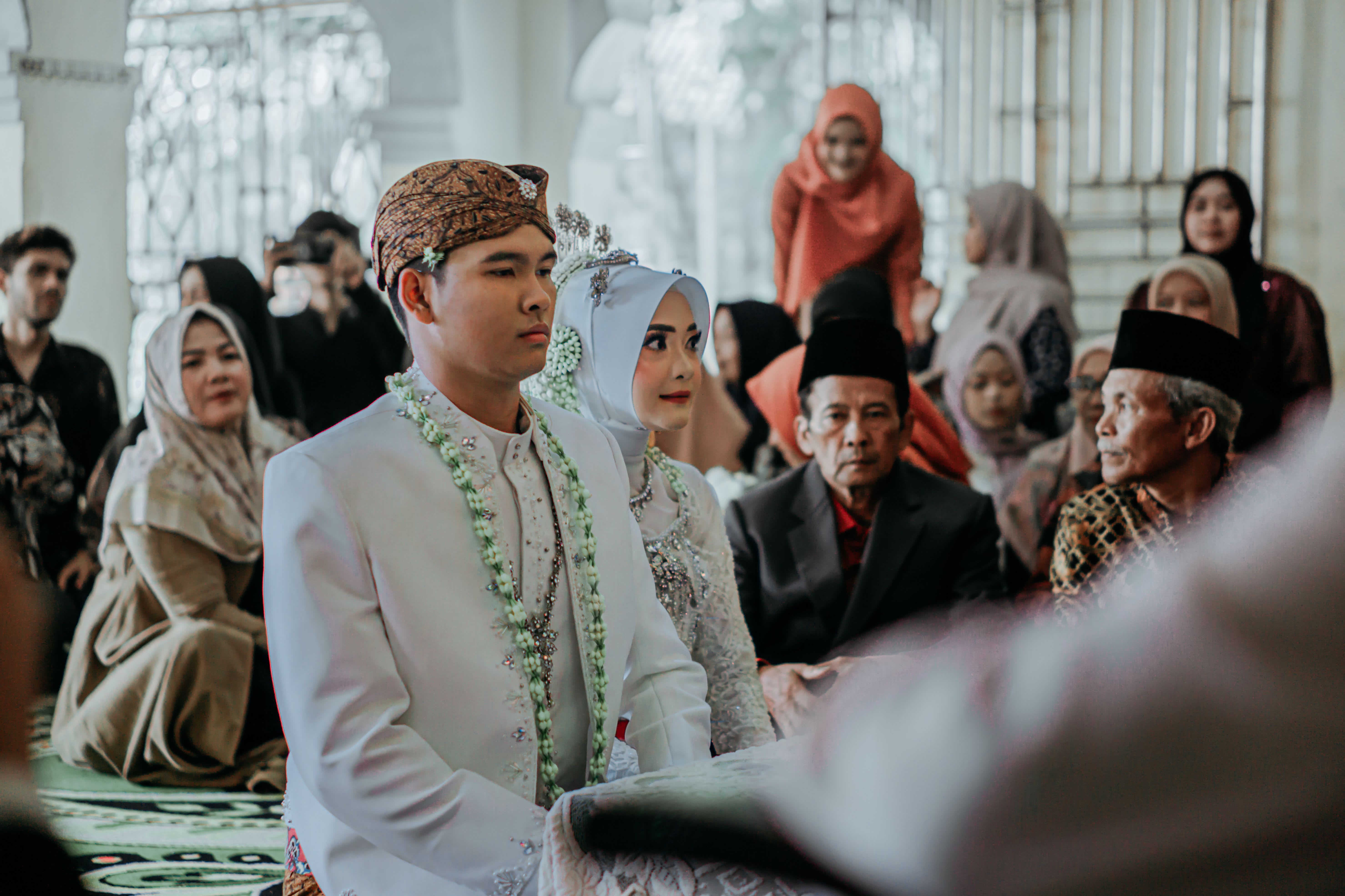 Muslim woman discussing her nikah with a family guardian and trusted Islamic adviser before marriage.