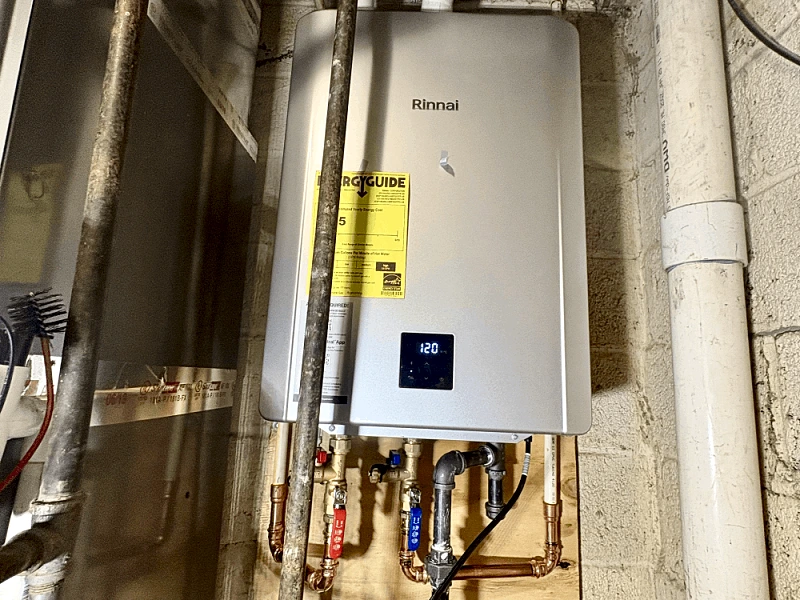 Professional tankless water heater installation showing gas line connections
