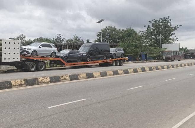 Car being loaded onto a transport truck for interstate delivery across Nigeria before Christmas