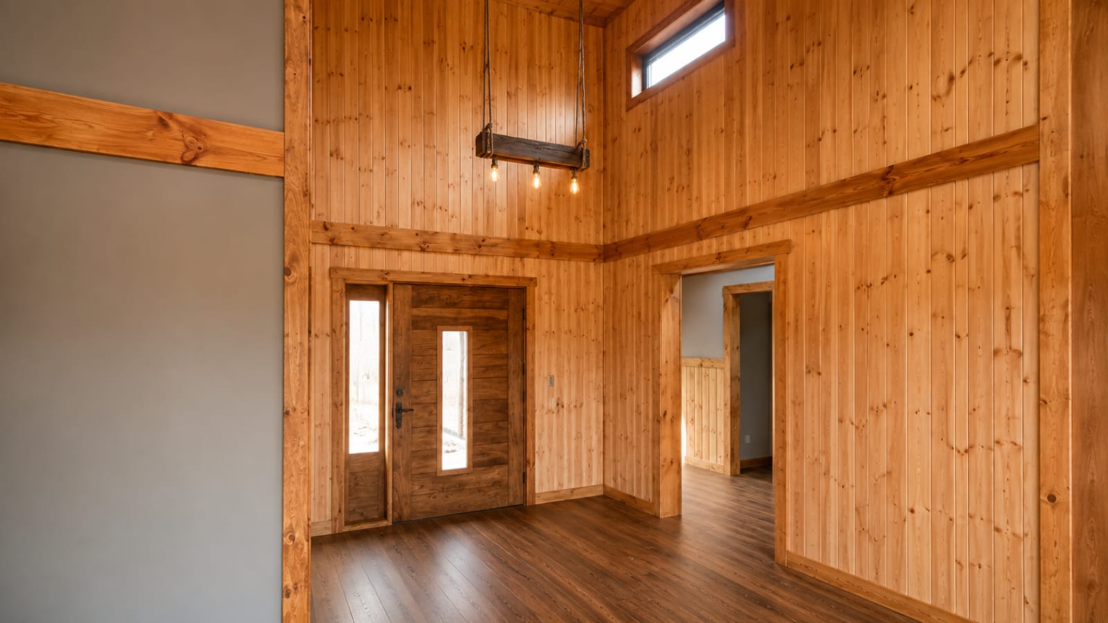 Interior de vivienda con doble altura y terminaciones en madera