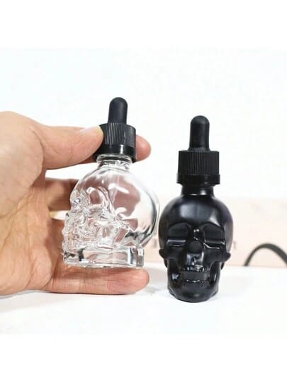 Gotero de vidrio en forma de calavera, ideal para almacenar líquidos