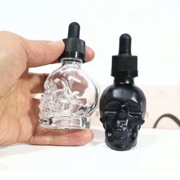 Gotero de vidrio en forma de calavera, ideal para almacenar líquidos