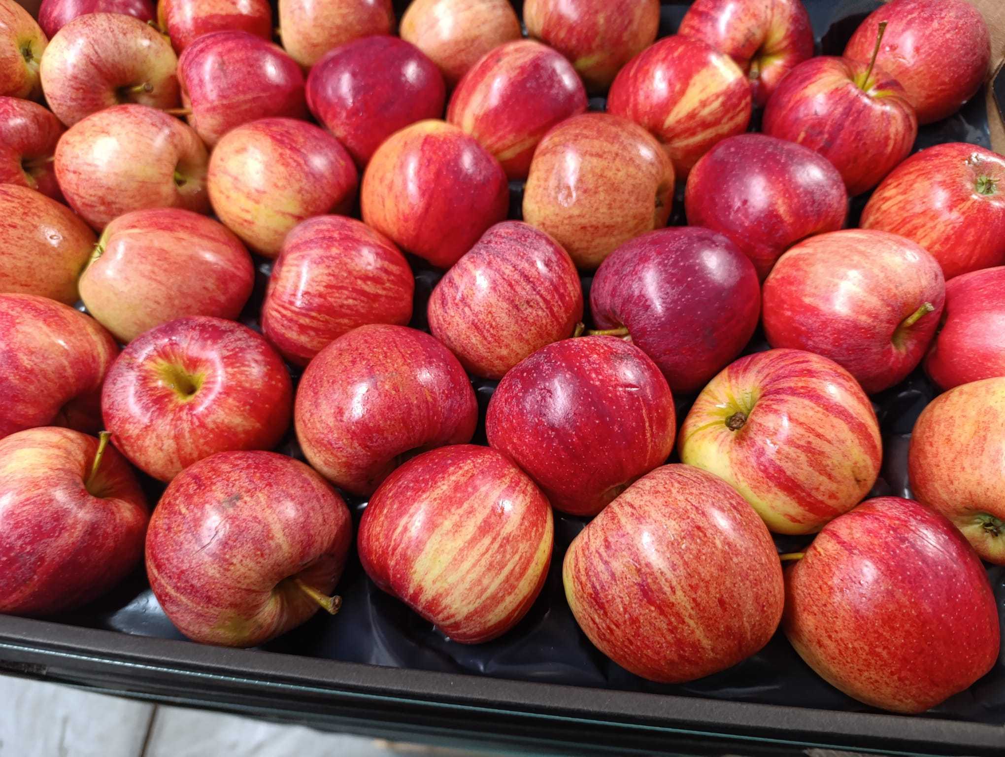 Red apples arranged on a wooden surface