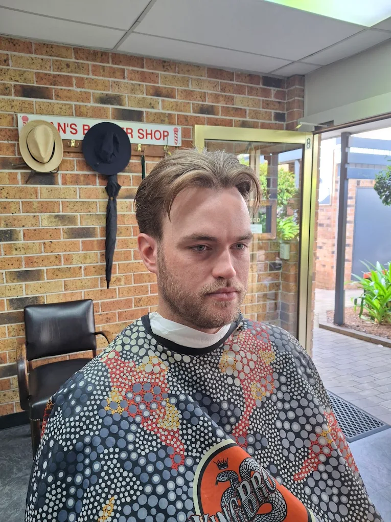 A customer relaxing during a hot towel shave.