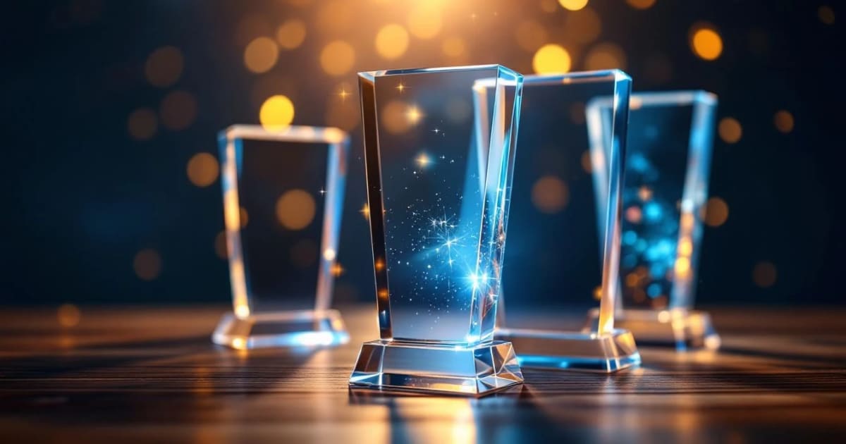 Crystal and acrylic employee anniversary awards with dramatic navy blue lighting and golden reflections