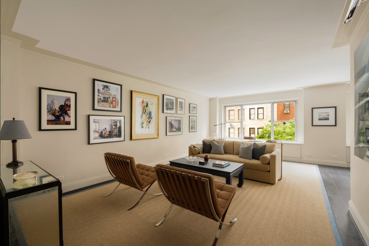 The living room of Residence 4R, treetop views through the window wall