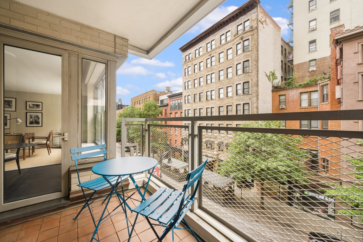 The private terrace with bistro table, in the treetops over West 8th Street