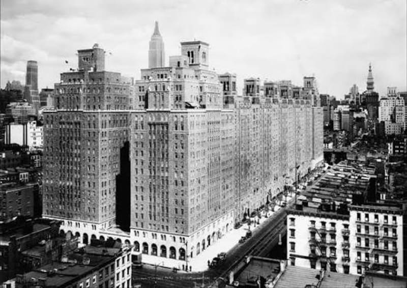 A period aerial photograph of London Terrace, the Empire State Building in the distance