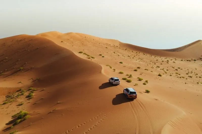 4x4 Land Cruiser dune bashing at sunrise in Al Khatim Desert Abu Dhabi