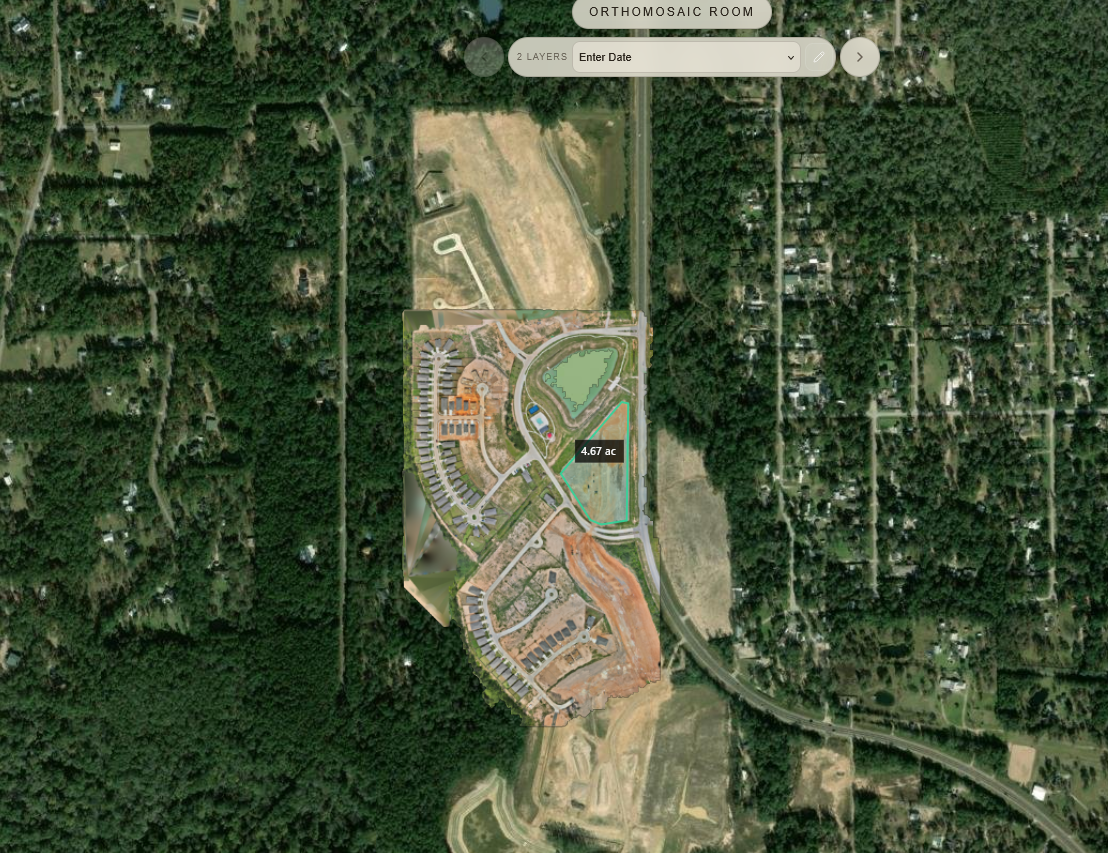 Construction progress orthomosaic in SpearAtlas showing dated map layers and an area measurement