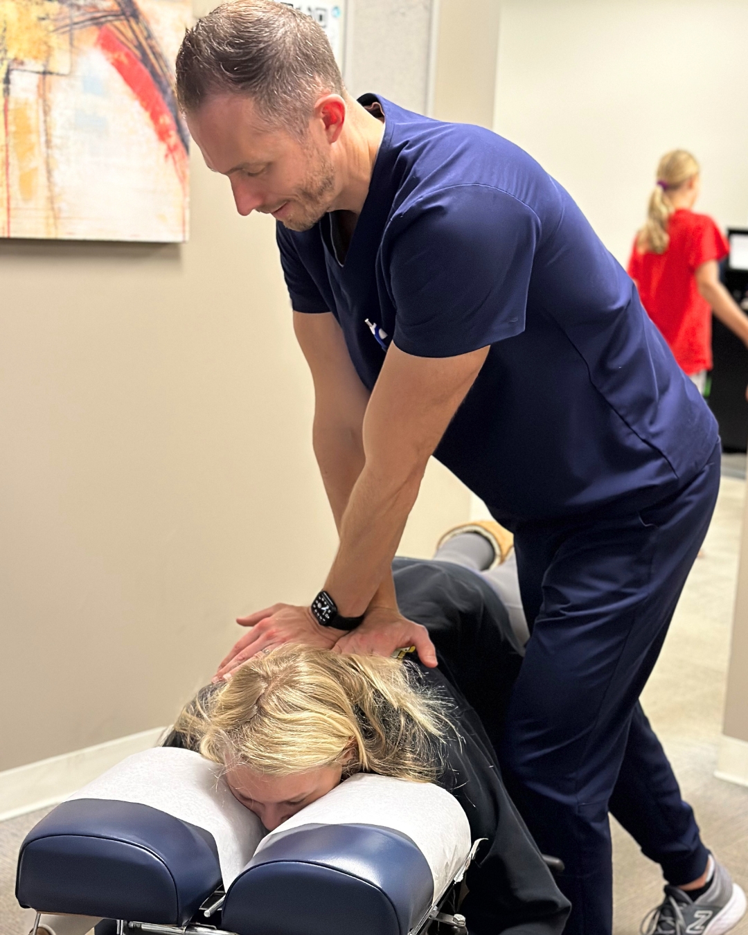 Dr. Chris Parrett, D.C., performing an adjustment on a patient at New Millennium Medical in Belvidere, Illinois