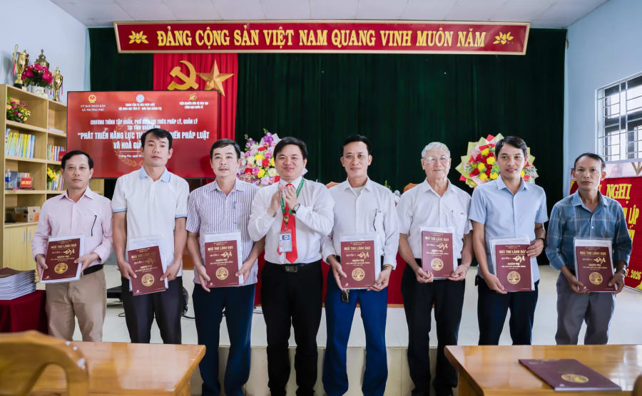 Trao tặng quyển sách “Quản trị gia sản đất đai bền vững” thuộc bộ sách “Ngũ thư lãnh đạo” cho đại diện các thôn nhằm phục vụ công tác nghiên cứu, tuyên truyền, phổ biến pháp luật tại cơ sở - Ảnh: H.T