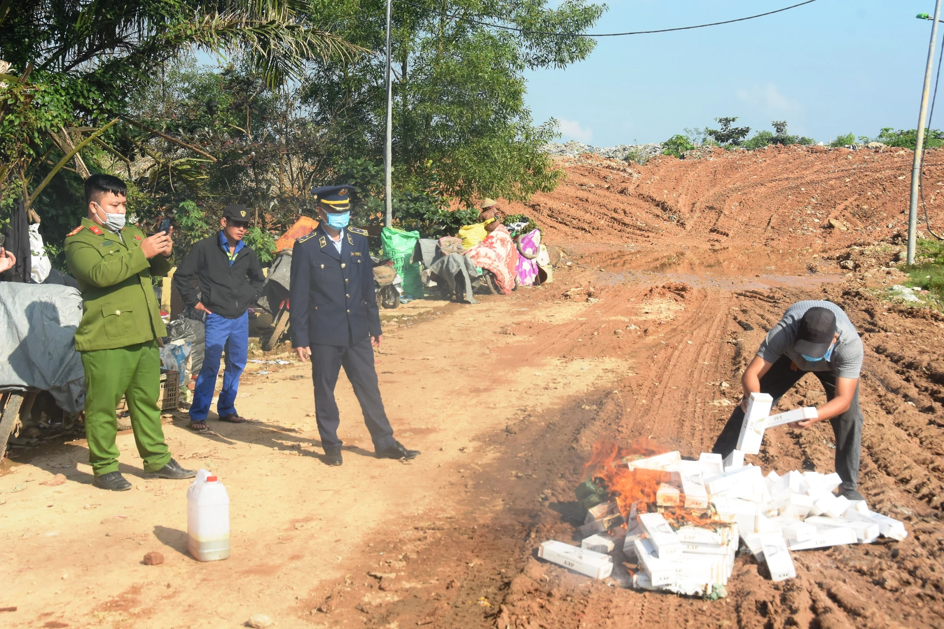 Đơn vị chức năng giám sát quá trình tiêu hủy thuốc lá điếu nhập lậu tại bãi chôn lấp rác phường Đông Hà - Ảnh: ĐV