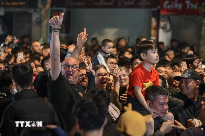 Người dân và du khách tại Hà Nội hân hoan chào đón năm mới 2026. (Ảnh: Hoàng Hiếu/TTXVN)